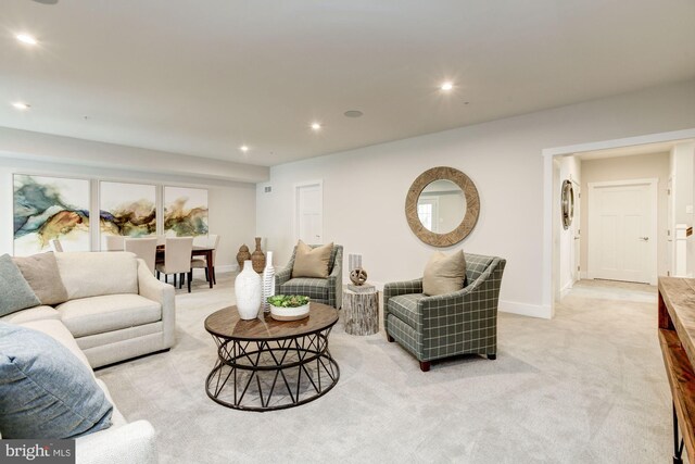 living room featuring recessed lighting, light colored carpet, and baseboards