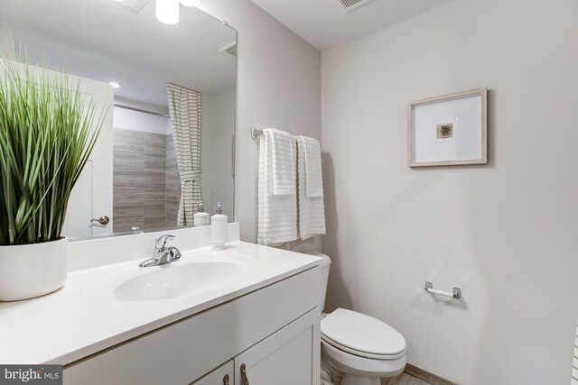 full bathroom with a shower, vanity, visible vents, and toilet