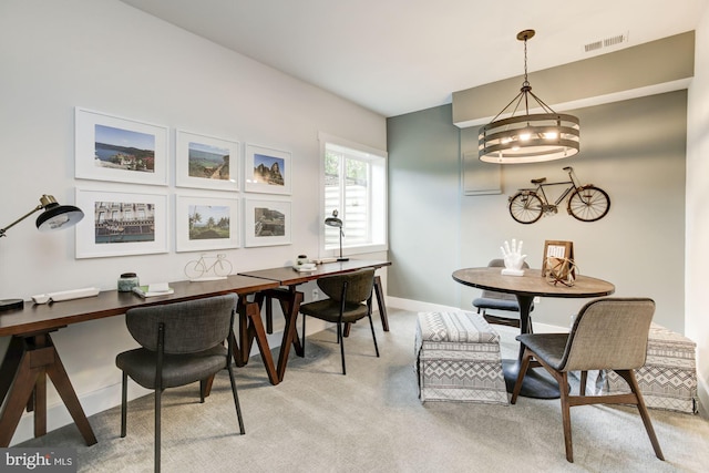 dining space featuring a chandelier, visible vents, light colored carpet, and baseboards