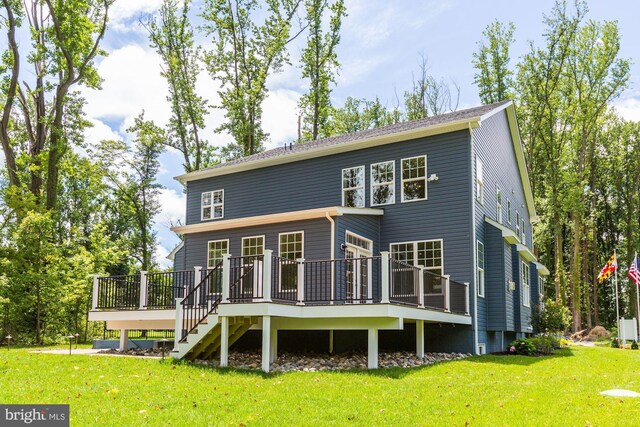 back of property featuring a yard, stairway, and a wooden deck