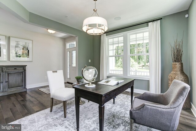 office area with dark wood-type flooring and baseboards