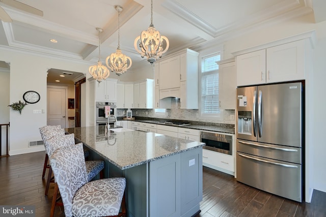 kitchen featuring stainless steel fridge, an inviting chandelier, gas stovetop, dark wood finished floors, and coffered ceiling