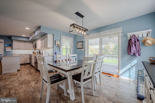 dining area featuring visible vents and plenty of natural light
