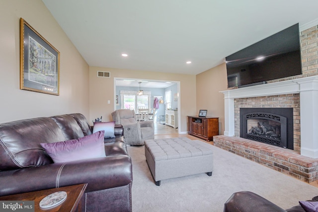 living room featuring carpet floors, a brick fireplace, visible vents, and recessed lighting