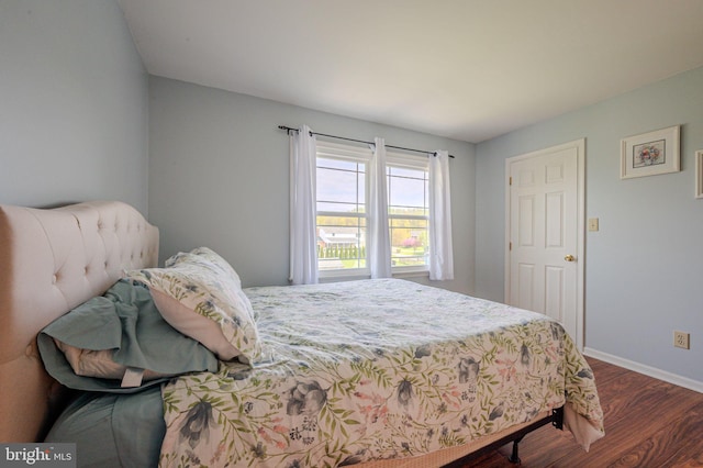 bedroom with baseboards and wood finished floors