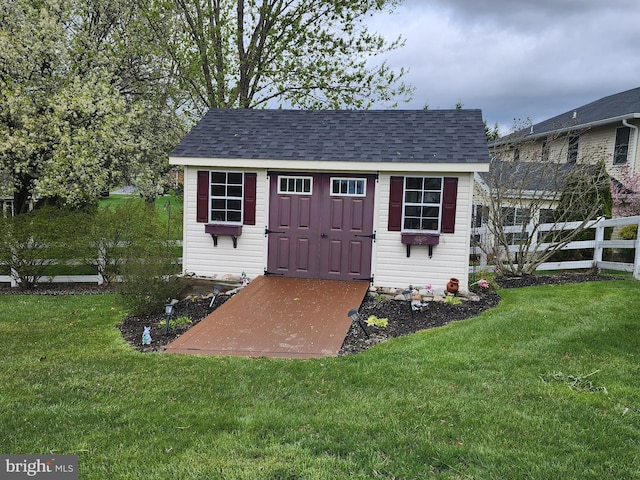 view of shed featuring fence