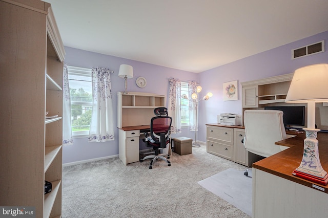 home office featuring light carpet, baseboards, and visible vents