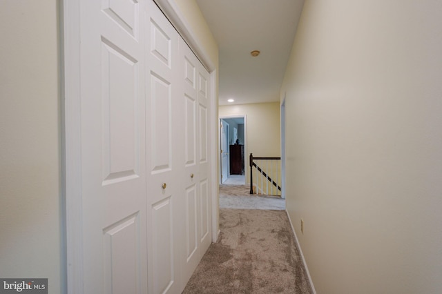 corridor with baseboards, carpet flooring, an upstairs landing, and recessed lighting