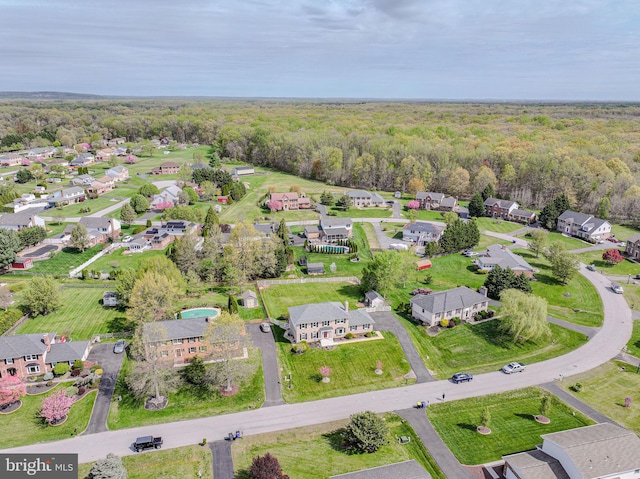 birds eye view of property featuring a view of trees and a residential view