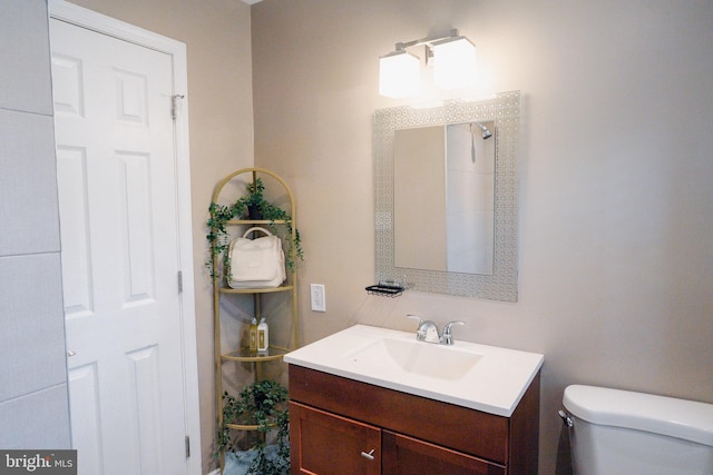 full bath featuring toilet and vanity