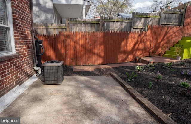 view of patio / terrace with central AC and fence