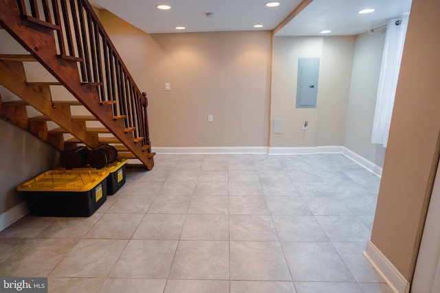 interior space with light tile patterned floors, baseboards, electric panel, recessed lighting, and stairs