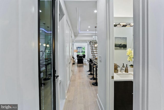 interior space featuring recessed lighting, light wood-style flooring, and a sink