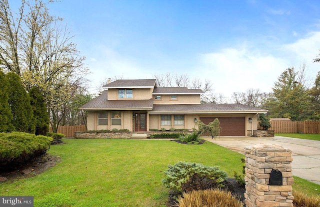 prairie-style house featuring stucco siding, driveway, a front lawn, a garage, and fence