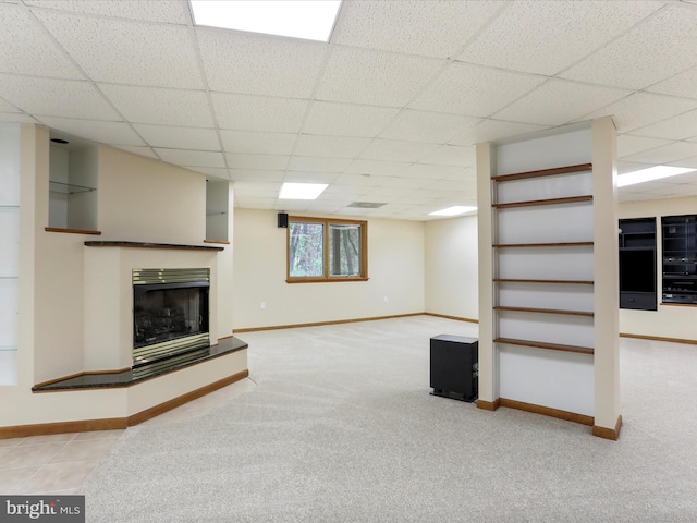 11035 Bennie Duncan Rd, Frederick, MD 21701 - unfurnished living room with baseboards, a drop ceiling, a fireplace with raised hearth, and carpet floors