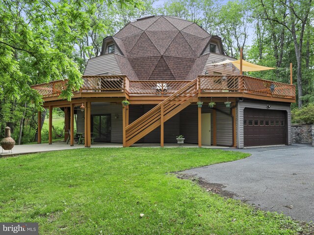11035 Bennie Duncan Rd, Frederick, MD 21701 - rear view of house featuring a deck, driveway, a yard, a patio, and a garage