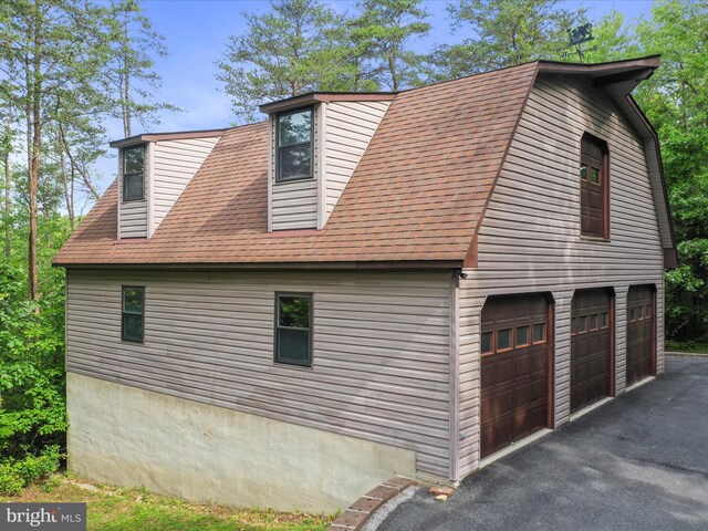 11035 Bennie Duncan Rd, Frederick, MD 21701 - view of home's exterior with driveway, an attached garage, and roof with shingles