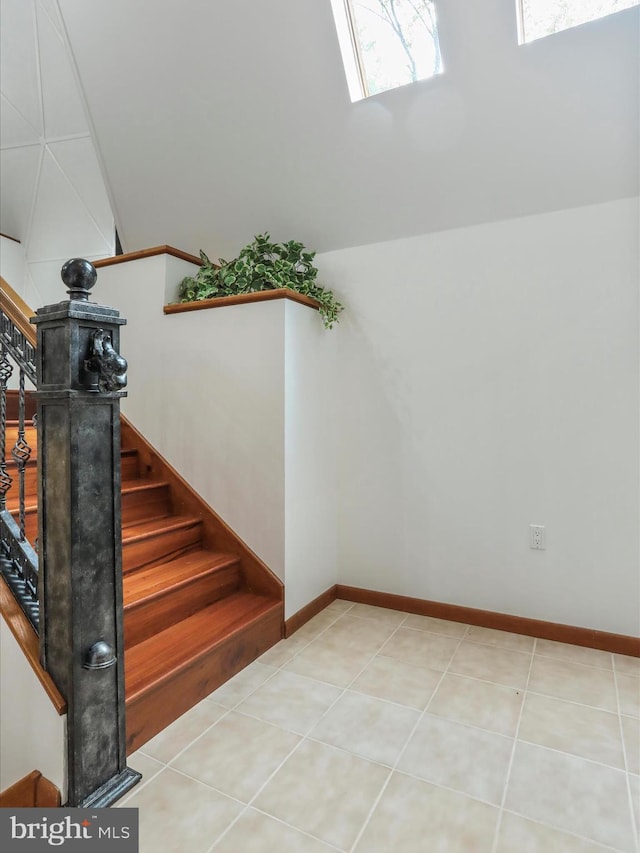 11035 Bennie Duncan Rd, Frederick, MD 21701 - staircase featuring lofted ceiling, a skylight, and baseboards