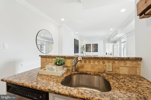 kitchen featuring tasteful backsplash, recessed lighting, light stone countertops, dishwasher, and a sink