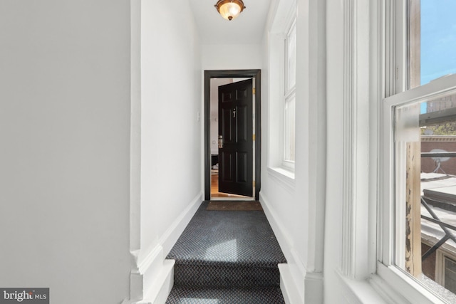 doorway featuring baseboards