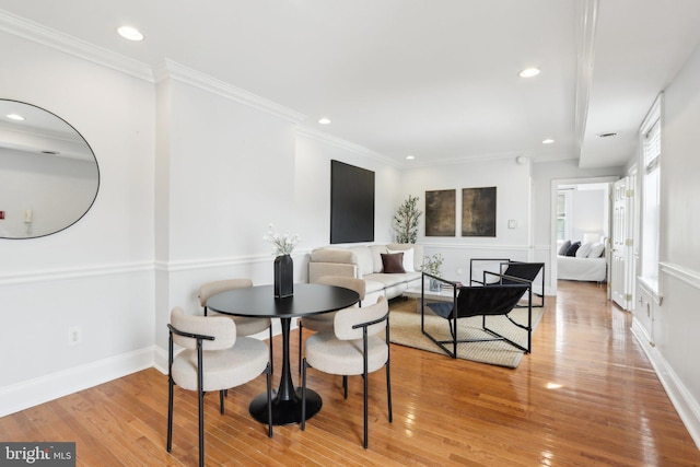 dining space featuring ornamental molding, recessed lighting, light wood finished floors, and baseboards