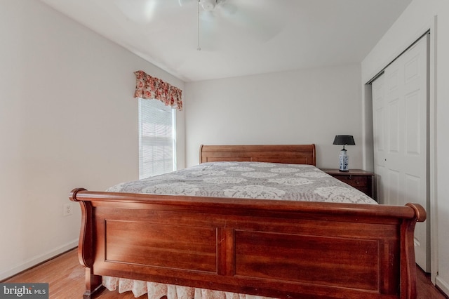 bedroom with baseboards, ceiling fan, and wood finished floors