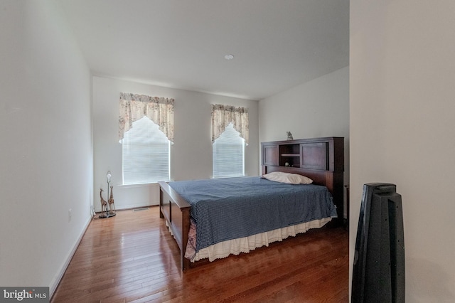 bedroom with baseboards and wood-type flooring