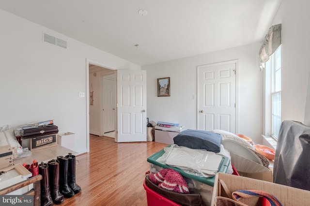 bedroom featuring light wood finished floors and visible vents