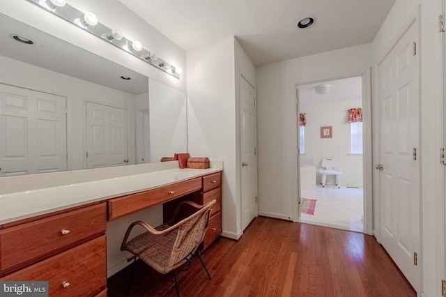 bathroom with vanity, baseboards, and wood finished floors