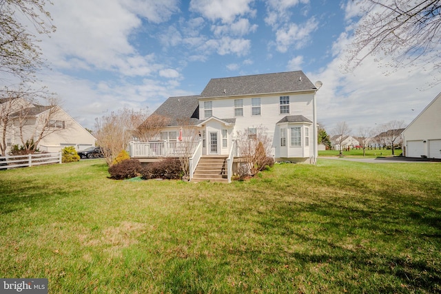back of house featuring a lawn, fence, and a wooden deck