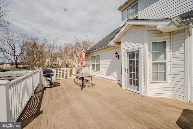 deck featuring area for grilling and outdoor dining area