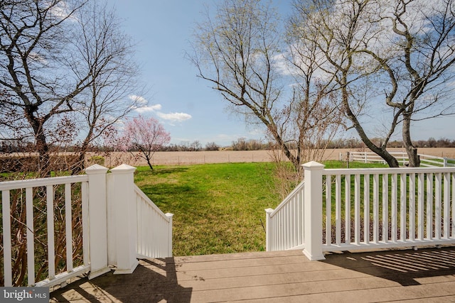 wooden terrace with a lawn