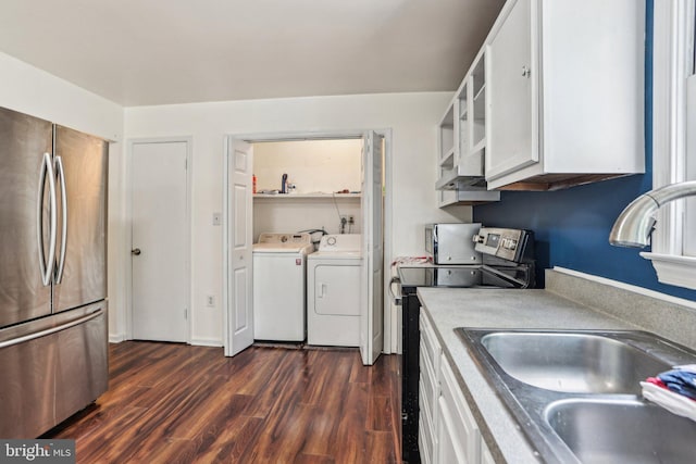 kitchen featuring a sink, white cabinetry, separate washer and dryer, dark wood-type flooring, and appliances with stainless steel finishes