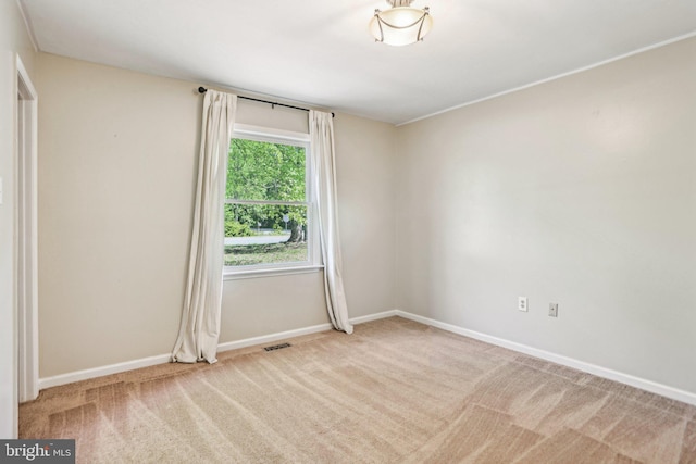 carpeted empty room with visible vents and baseboards