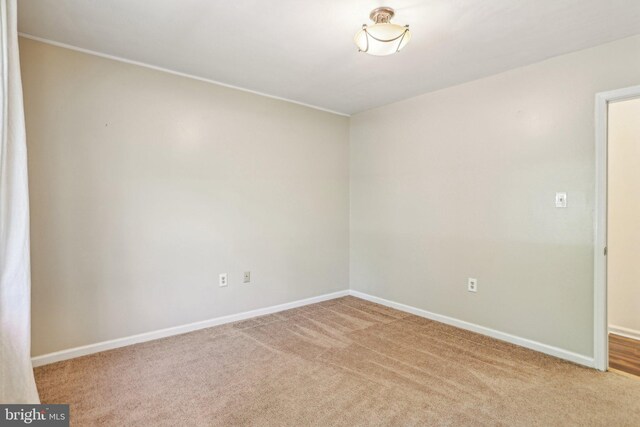 carpeted spare room with baseboards
