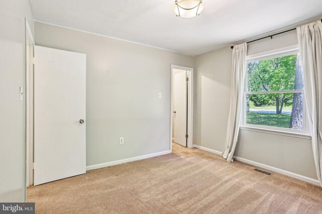 unfurnished bedroom with visible vents, baseboards, and carpet flooring