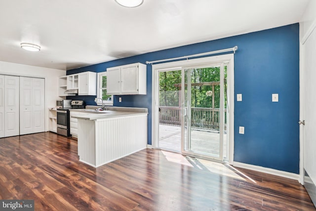 kitchen featuring open shelves, a sink, a peninsula, stainless steel electric stove, and white cabinetry