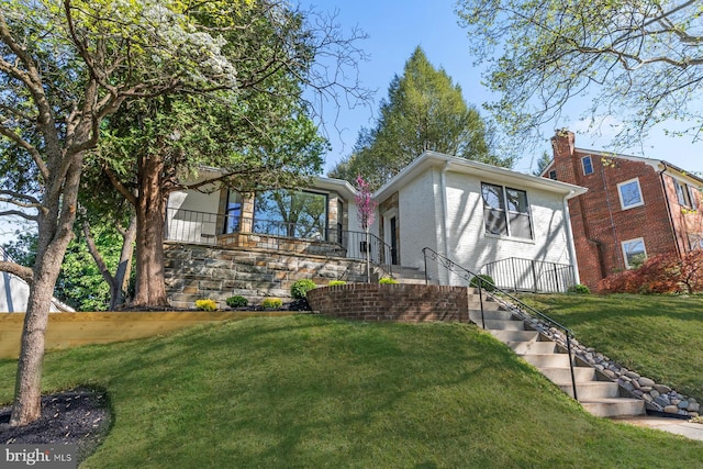 exterior space with stairway and a yard