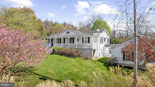 back of house featuring covered porch and a yard