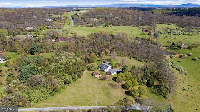 birds eye view of property featuring a wooded view