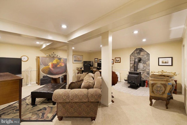 carpeted living room featuring ornamental molding, a wood stove, and recessed lighting