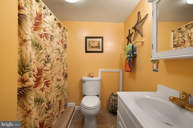 bathroom with tile patterned floors, vanity, and toilet