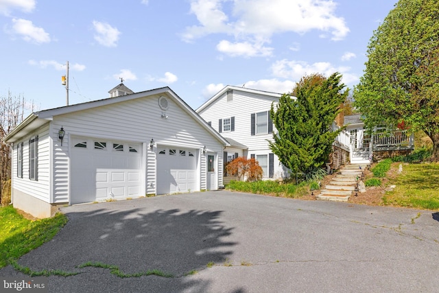 view of front of property featuring an outbuilding and aphalt driveway
