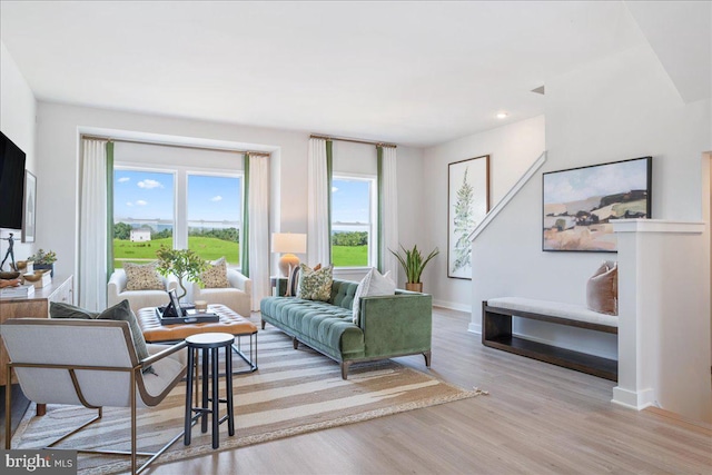 living room with baseboards, recessed lighting, plenty of natural light, and wood finished floors