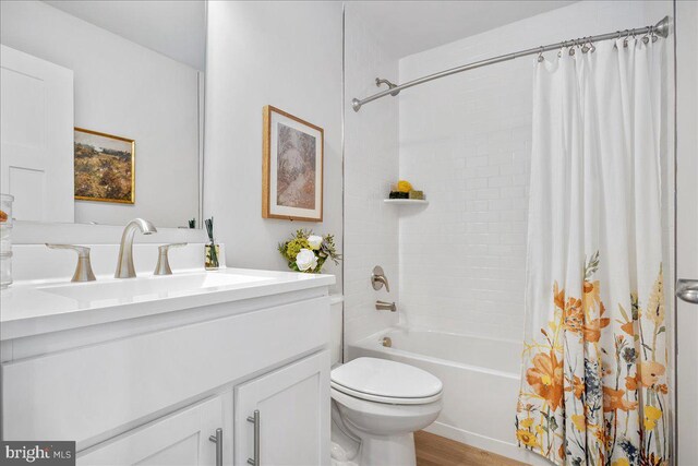 full bath featuring shower / bath combo, toilet, vanity, and wood finished floors