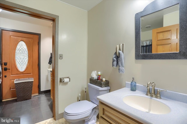 full bath with vanity, toilet, baseboards, and tile patterned floors