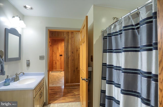 full bath with vanity, wood finished floors, and curtained shower