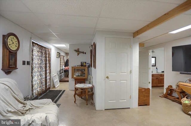 living area featuring a paneled ceiling