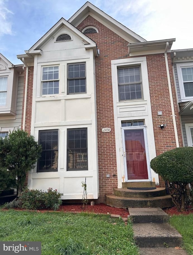 view of front of property featuring brick siding