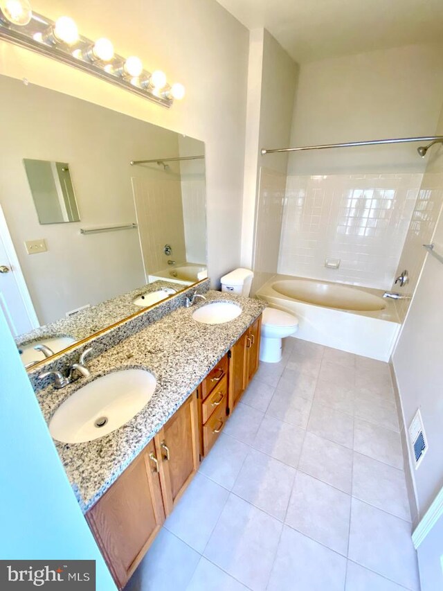 bathroom featuring bathing tub / shower combination, tile patterned flooring, double vanity, and toilet
